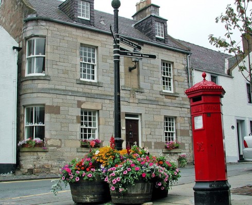 A view in the centre of Falkland
The attractive village of Falkland was made Scotland's first conservation village in 1970.  Note the unusual curved glass windows on the corner of the house.
