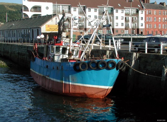 Fishing boat tied up at old Largs pier
The old stone pier at Largs was replaced in 2009 by a larger concrete and steel construction so that the new larger car ferry could be berthed at the pier over night.  The TT registration number on this boat indicates her home port is Tarbert [url=http://www.streetmap.co.uk/map.srf?X=220045&Y=659490&A=Y&Z=120/] Map location. [/url]
