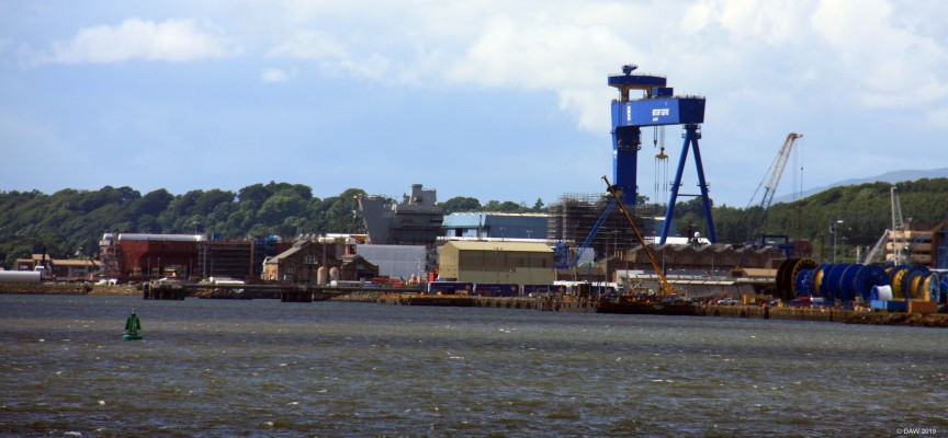 HMS Prince of Wales, Rosyth, 2016
The second of the two Queen Elizabeth class aircraft carriers being assembled at Rosyth.  She was built in sections and the parts floated from varies yards around the UK to be assembled here at Rosyth.  The two bridges are already painted grey because they were built as complete structures and lifted on to the ship.  The stern is on the left.
