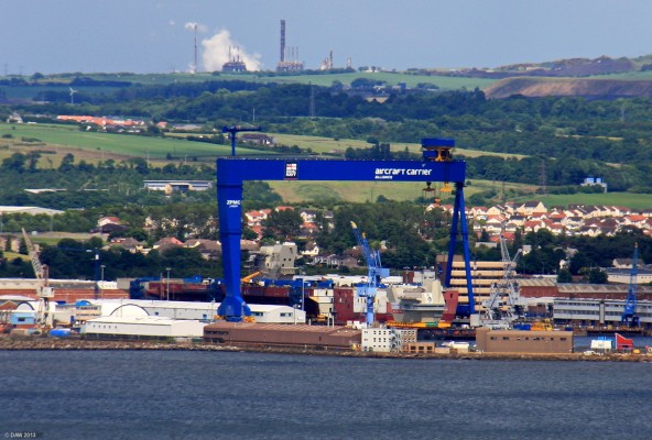 HMS Queen Elizabeth, Dry dock, Rosyth, 2011
The Royal Navy's new 65,000 ton Aircraft carrier being assembled at Rosyth.  Parts are being constructed at varies yards around the UK and floated on barges to Rosyth for final assembly.  You can see the aft air operations bridge sitting on the dock side waiting to lifted onto the ship by the huge (Chinese) crane that was purpose built for the job. The forward bridge is already sitting on the deck.
