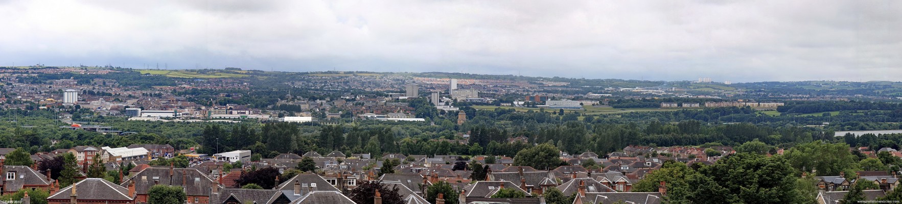Panoramic view over looking Hamilton
Taken from the tower at Motherwell Heritage centre.  On the left hand side Hamilton spreads up the hill as far as you can see, in the centre you can pick out the Hamiltion Mausoleum with Hamilton Race Course to the right.  On the extreme right is Strathclyde Loch.  On the right hand side the tower blocksof East Kilbride can be seen on top of the hill.  [url=http://www.streetmap.co.uk/map.srf?X=274947&Y=657015&A=Y&Z=120/] Map location. [/url]
