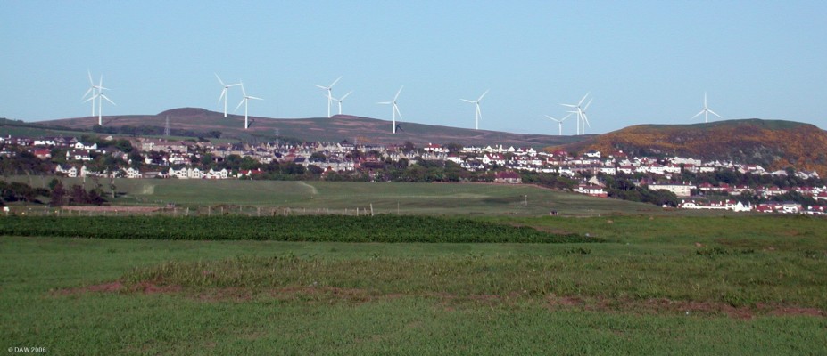 Haupland Muir Windfarm as seen from Farland Head near Portencross
West Kilbride and Seamill lie in front of the windfarm, but I'm not going to suggest as to where the dividing line is between the two as I'm told its a source of local friction!  [url=http://www.multimap.com/map/browse.cgi?lat=55.6975&lon=-4.9032&scale=25000&icon=x/] Map Location[/url]
