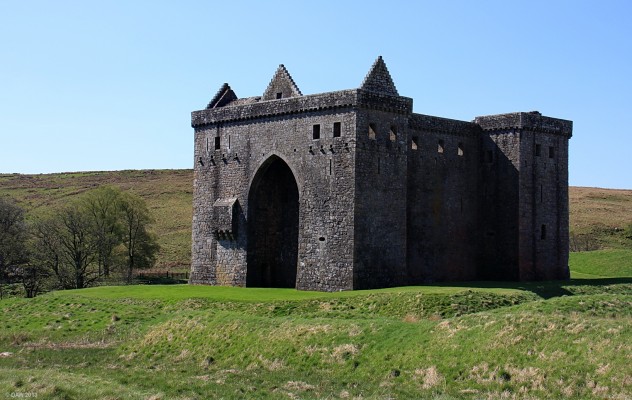 North East view of Hermitage Castle
For 400 years this impressive ruin served as the "guardhouse of the bloodiest calley in Britain"  [url=http://www.historic-scotland.gov.uk/propertyresults/propertyoverview.htm?PropID=PL_149] Hermitage Castle's [/url] proximity to the English border made it a particular prize for both countries.  The stone castle was built in 1240 by Sir Nicholas de Soules but there was a wooden castle here long before.  There are still the remains of large earthworks all around the castle.
