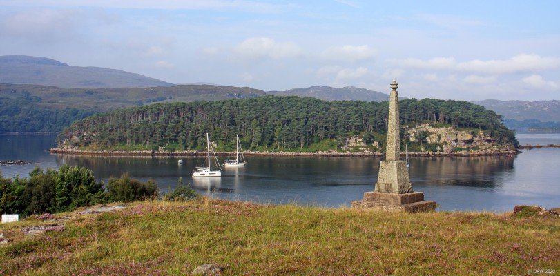 Shieldaig Island
Looking out to Shieldaig Island from above the village of Shieldaig.  Shieldaig War memorial is on the right.  The island is covered in mostly Scots Pine that are thought to have been planted in the 1870s to provide poles for drying fishing nets and masts for fishing boats.  Since 1970 the island has been in the care of the National Trust For Scotland and is now a haven for wildlife  [url=https://streetmap.co.uk/map.srf?X=181808&Y=854295&A=Y&Z=120/] Map location. [/url]
