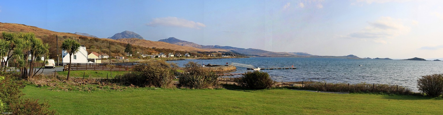 The Bay of Small Isles, Jura
An early morning view looking out from in front of the Jura Hotel.  The white building on the left beihind the palm trees is the Jura Store.  In the distance you can see the Paps of Jura and on the right are The Small Isles.  [url=http://www.streetmap.co.uk/map.srf?X=152774&Y=666992&A=Y&Z=115/] Map location. [/url]
