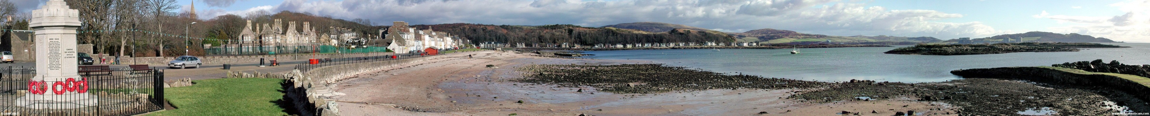 Millport Seafront Panorama, 2005
Taken on a very cold February day, hence the lack of people.  On the left hand side is the sorry sight of the Garrison building before its restoration was started.  In the centre you see the houses of Kames bay in the distance and on the extreme right you can just make out Portenscross castle on the mainland.  [url=http://www.streetmap.co.uk/streetmap.dll?G2M?X=216280&Y=654895&A=Y&Z=3/]Map location[/url]
