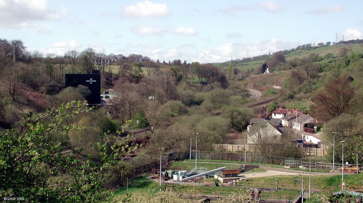 Neilston Sewage works
Probably not a view the tourist board would promote.  The sewage treatment works are in the foreground, left of centre is Clyde Leather works which was Broadlie Mill, above that and over the hill you can see the top of the former Crofthead Mill.  Neilston Low station was located just round the bend in the railway track that runs along parallel to the road.  [url=http://www.streetmap.co.uk/map.srf?X=248012&Y=657877&A=Y&Z=115/] Map location. [/url]
