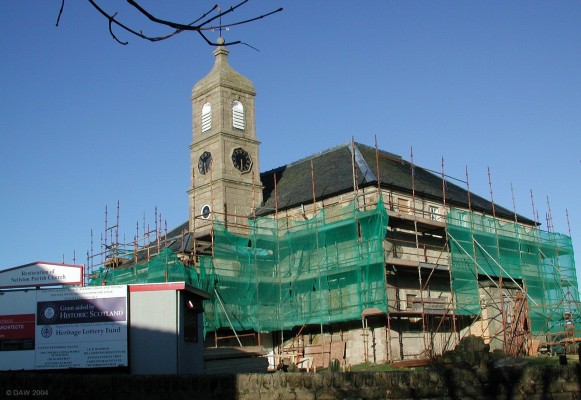 Neilston Parish Church, February 2004
The Parish Church in the midst of its major restoration.  The outer rendering has been removed revealing the stonework below, although I believe this will be re-instated later.  A great deal of the work is taking place inside. The total cost is something like ?375,000, much of the money has come from the UK lottery fund.
