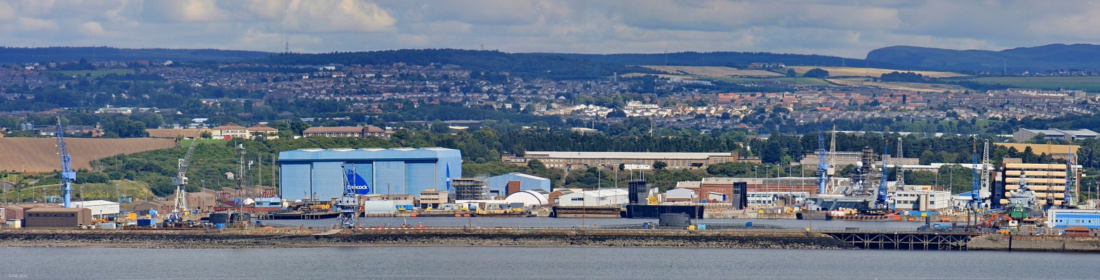 Rosyth Dockyard, River Forth
Built in 1909 when the Royal Navy was building up its fleet to compete with Germany.  Today it is government owned but run by a contractor.  This photo taken in 2010 from the roof of Hopetoun House shows the 7 decomissioned Nuclear Submarines, 4 Polaris boats and 3 attack submarines.  Towards the right is the Aircraft Carrier, HMS Illustrious, undergoing what will almost certainly be her last major refit. [url=http://www.streetmap.co.uk/map.srf?X=308877&Y=679074&A=Y&Z=115/] Map location.[/url]
