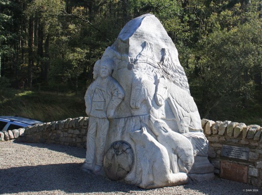 The Scott, Wilson Memorial, Glen Prosen
Erected in 2012 to replace an earlier one.  It is a memorial to Antarctic explorers Captain Scott and Dr Wilson who planned their ill-fated expedition to the south pole in 2012 at Wilson's home, nearby Burnside Cottage.  The Sculpture is carved in Granit and includes both men, their ponies, dogs and also Penguins on the side you don't see in this view. [url=http://streetmap.co.uk/map?X=337172&Y=760620&A=Y&Z=120/] Map location. [/url]
