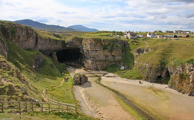 Looking down at Smoo Cave, Durness
The cave name is thought to derive from the Norse 'smjugg' or 'smuga' meaning a hole or hiding-place.  There are various tales of the cave being used as a hide away over the centuries and also as a place where local highwayman, McMurdo, would murder his victims by throwing them down the sink hole at the rear.  [url=http://www.streetmap.co.uk/map.srf?X=241825&Y=967562&A=Y&Z=115&ax=241888&ay=967132/] Map location. [/url]

