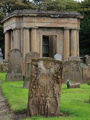 St Quivox Church Graveyard, Auchincruive
There are graves as old as 1657 in the graveyard at St Quivox Church, this one has an Adam & Eve carving on one side.  In the background is the Mausoleum built in 1822 by the Campbells of Craigie. [url=http://www.streetmap.co.uk/map.srf?X=237496&Y=624045&A=Y&Z=115/] Map location. [/url]
