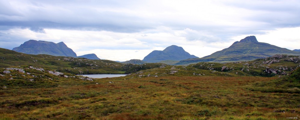 Suilven
If I'm perfectly honest I'm not sure what this view is other than it was taken somewhere on the road between Lochinver and Drumbeg.  The Mountain in the centre looks like Suilven rising to some 732m.
