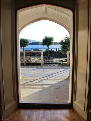 Looking out from The Garrison, Millport
And today we'll look through the arched window, if you aren't of a certain age you won't recognise that phrase.  Palm trees and blue sky, is it a Pacific Island?  No, its the next best thing, Millport.  [url=http://www.streetmap.co.uk/map.srf?X=216415&Y=655015&A=Y&Z=115/] Map location. [/url]

