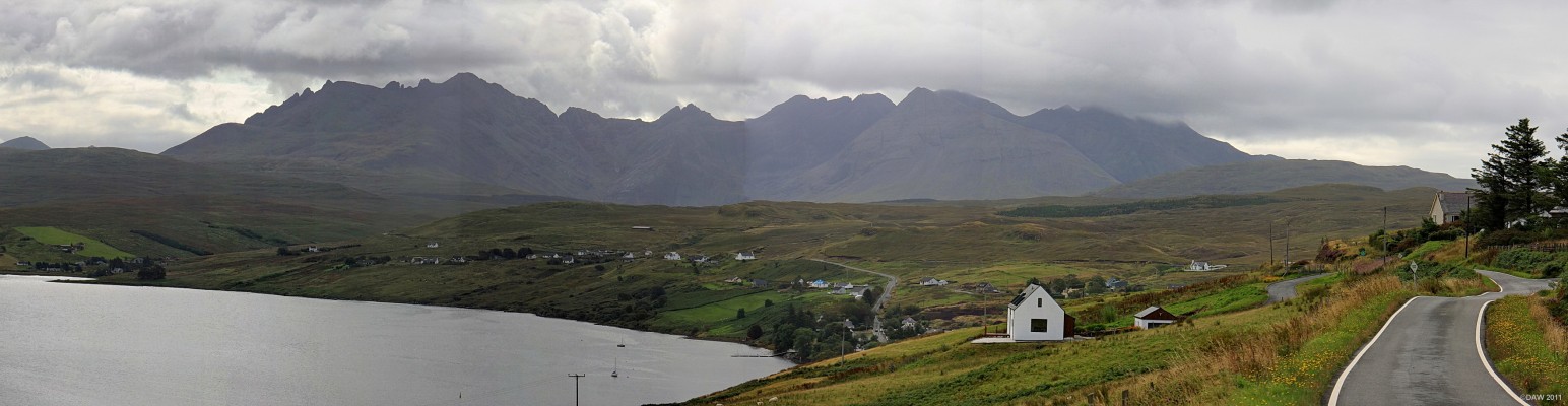 The Cullins from Loch Harport, Skye
The Cullin mountains dominate the sky line, the highest peak on the range rises to some 986m.  The small village of Carbost is low down in the centre of the picture. [url=http://www.streetmap.co.uk/map.srf?X=137177&Y=832699&A=Y&Z=120&ax=137177&ay=832699/] Map location. [/url]
