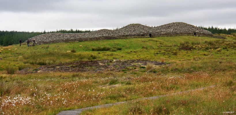 The Long Cairn, Camster
A side view of the Long Cairn at Camster on a gloomy summer day just as the rain started.  The people on the left give an idea of the scale, it is some 61m in length and dates from 5,000 years ago.  There are two chambers although it is thought there might be a third. it also thought it may have started as three round Cairns that were joined at some later date. [url=http://streetmap.co.uk/map.srf?X=326064&Y=944085&A=Y&Z=115/] Map location. [/url]
