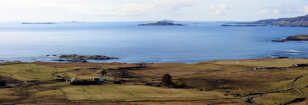 Island panorama from west coast of Mull
The flat island on the left is Staffa, to the right and behind is Bac Mor or Dutchmans Cap, then the larger island of Lunga, Little Colonsay is in front  along with Inch Kenneth.  Ulva is on the right hand side.  In the distance on the horizon you can just make out Tiree and Coll.  [url=http://www.streetmap.co.uk/map.srf?X=143970&Y=735910&A=Y&Z=130&ax=145210&ay=733910/] Map location. [/url]
