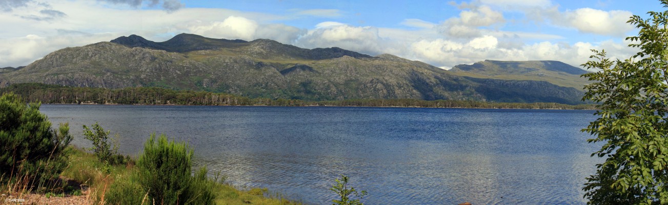 Loch Maree
A view of Loch Maree from Slattadale.  The line of trees along the centre of the photo are standing on some of the 40 or so Islands in the Loch.  They are said to be the nearest thing to natural woodland left in the British Isles, they are a fragment of the Caledonian Pine forest that once covered a large area of the Highlands. [url=http://streetmap.co.uk/map.srf?X=188807&Y=871825&A=Y&Z=126/] Map location. [/url]
