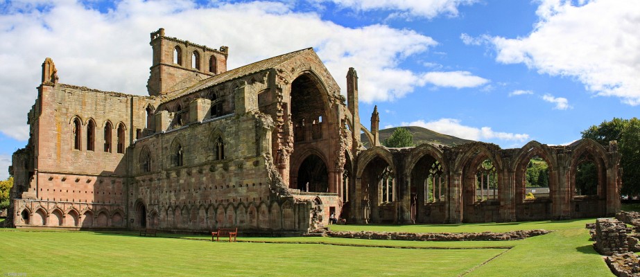 The ruins of Melrose Abbey
An Abbey was first built on this site by the Cistercian Monks in 1146.  Richard II, in retaliation for a raid by the Scots in 1385, sent a force North to destroy the Abbeys at Melrose, Dryburgh and Newbattle.  The Abbey that you see here today is the remains of what was rebuilt after that event. [url=http://www.streetmap.co.uk/map.srf?X=354807&Y=634223&A=Y&Z=115/] Map location. [/url]

