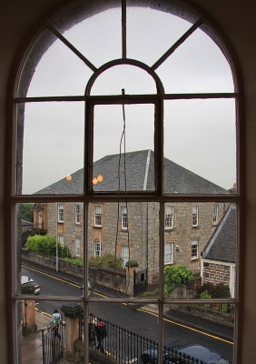 The old Gaelic Church, Oakshaw, Paisley
Looking out from a window in the High Church across the street to the old Gaelic Church.  It was built in 1793 by highlanders living in Paisley.  At that time services were conducted in Gaelic but was under control of the High Church.  In 1874 it was granted full status and became St Columba's.  In 1959 the congregation moved to a new church and the old building was eventually turned in to flats.
